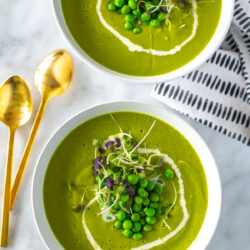 Two bowls of spring green pea soup.