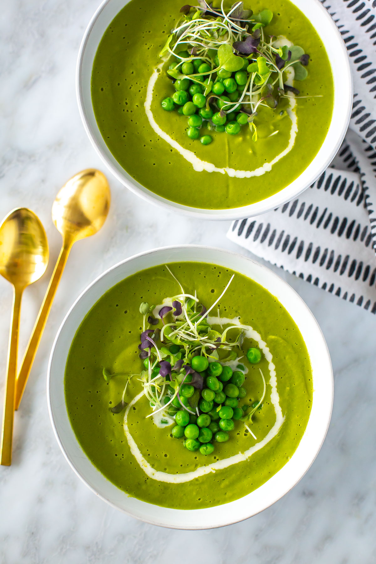 Two bowls of spring green pea soup.
