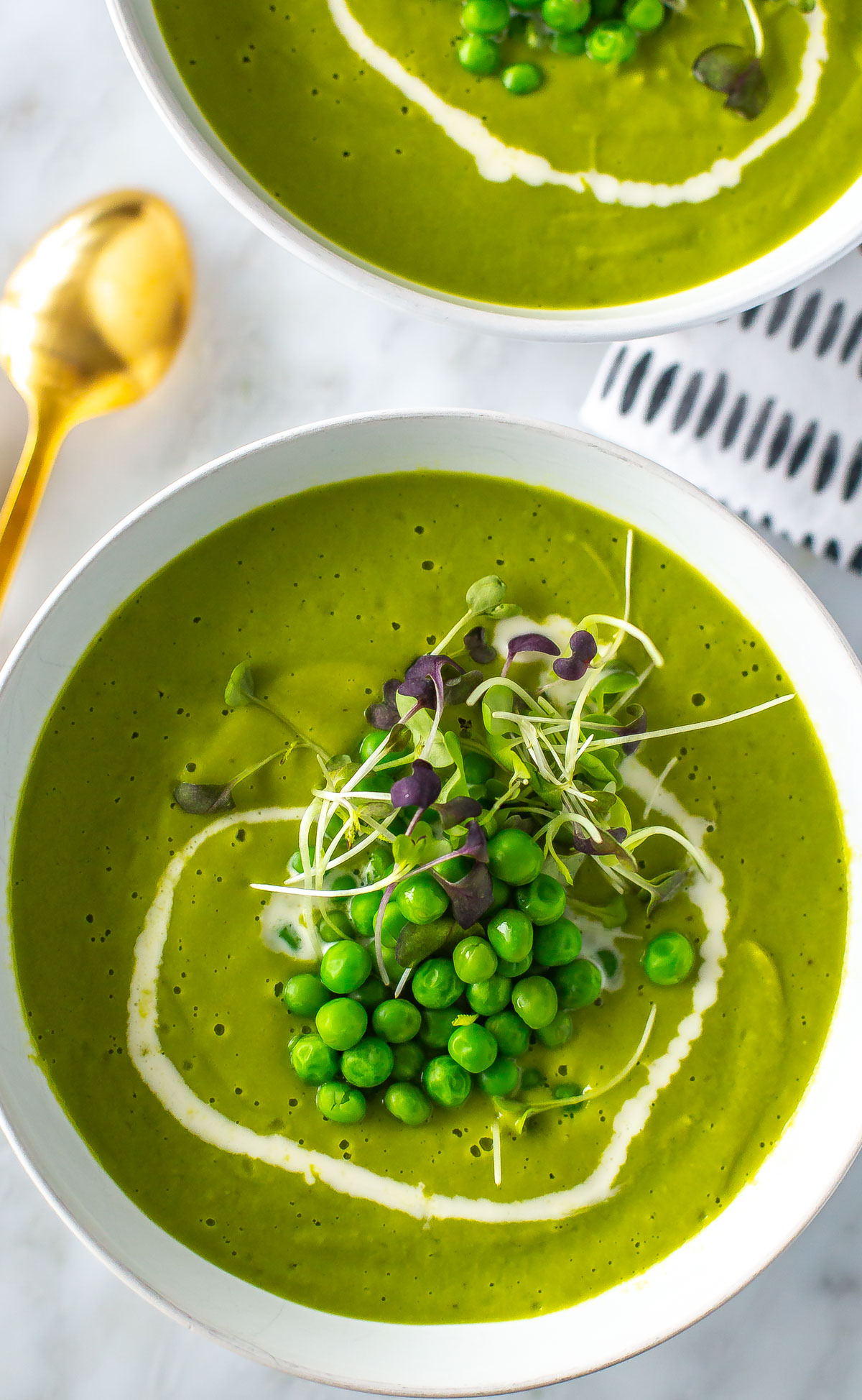 A close-up of a bowl of spring green pea soup.