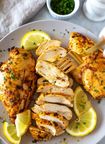 Sliced marinated chicken breast on a plate