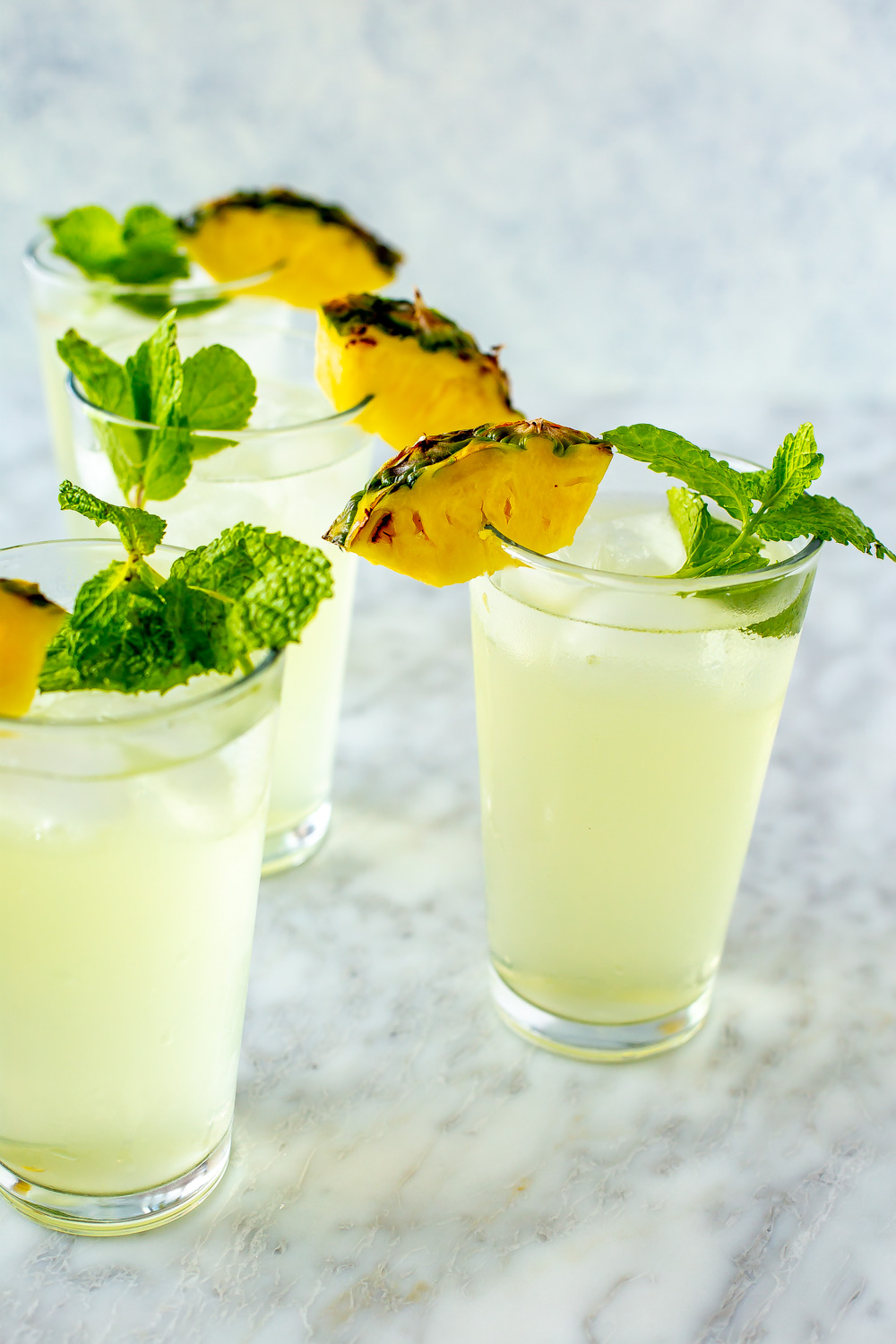 Pineapple coconut coolers in tall glasses.