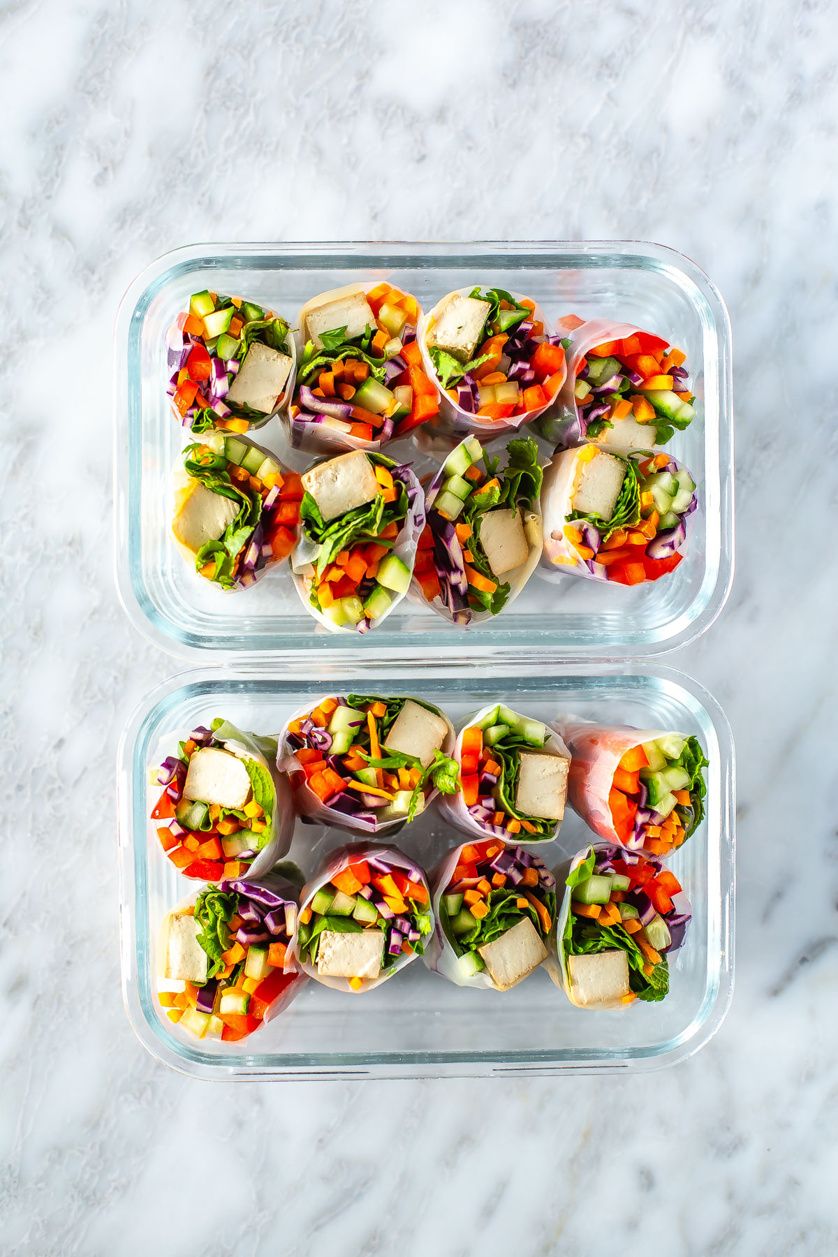 Two meal prep containers filled with summer rolls.