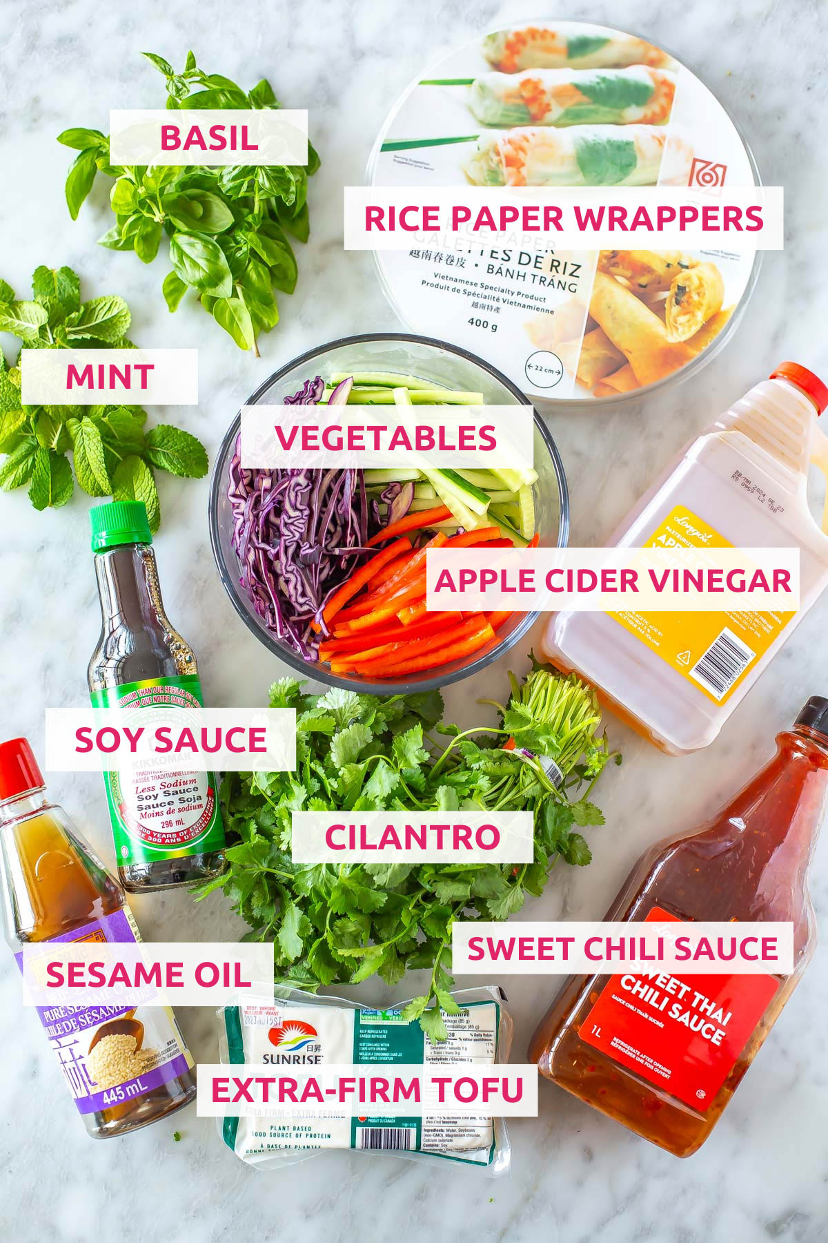 Ingredients for summer rolls: rice paper wrappers, veggies, basil, mint, apple cider vinegar, soy sauce, sesame oil, cilantro, tofu and sweet chili sauce.