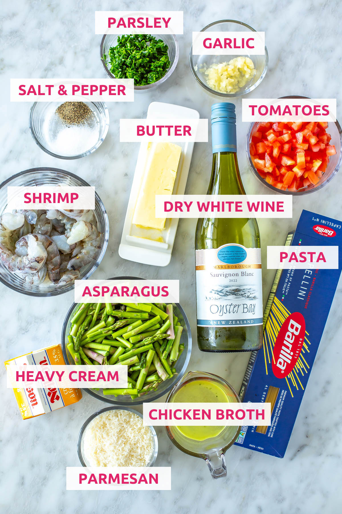 Ingredients for copycat Olive Garden Shrimp Scampi: shrimp, asparagus, heavy cream, parmesan, chicken broth, pasta, dry white wine, tomatoes, butter, salt, pepper, parsley and garlic.