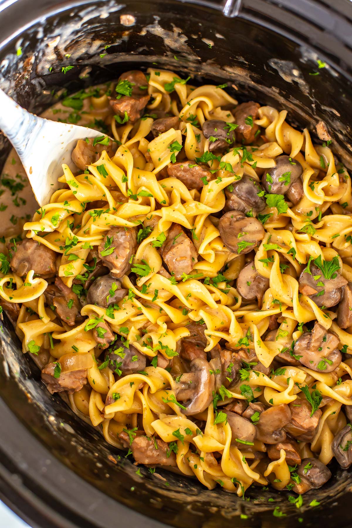 A close-up of beef stroganoff in a crockpot. 