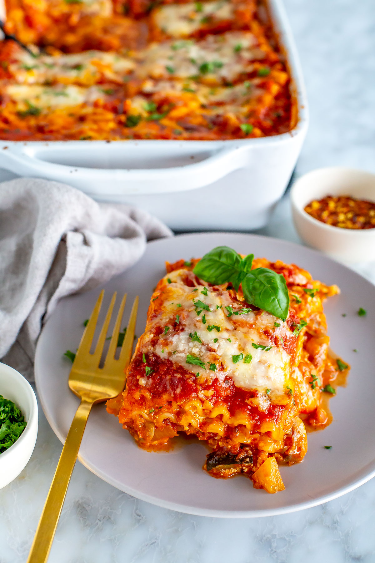 A slice of vegetarian lasagna on a plate.