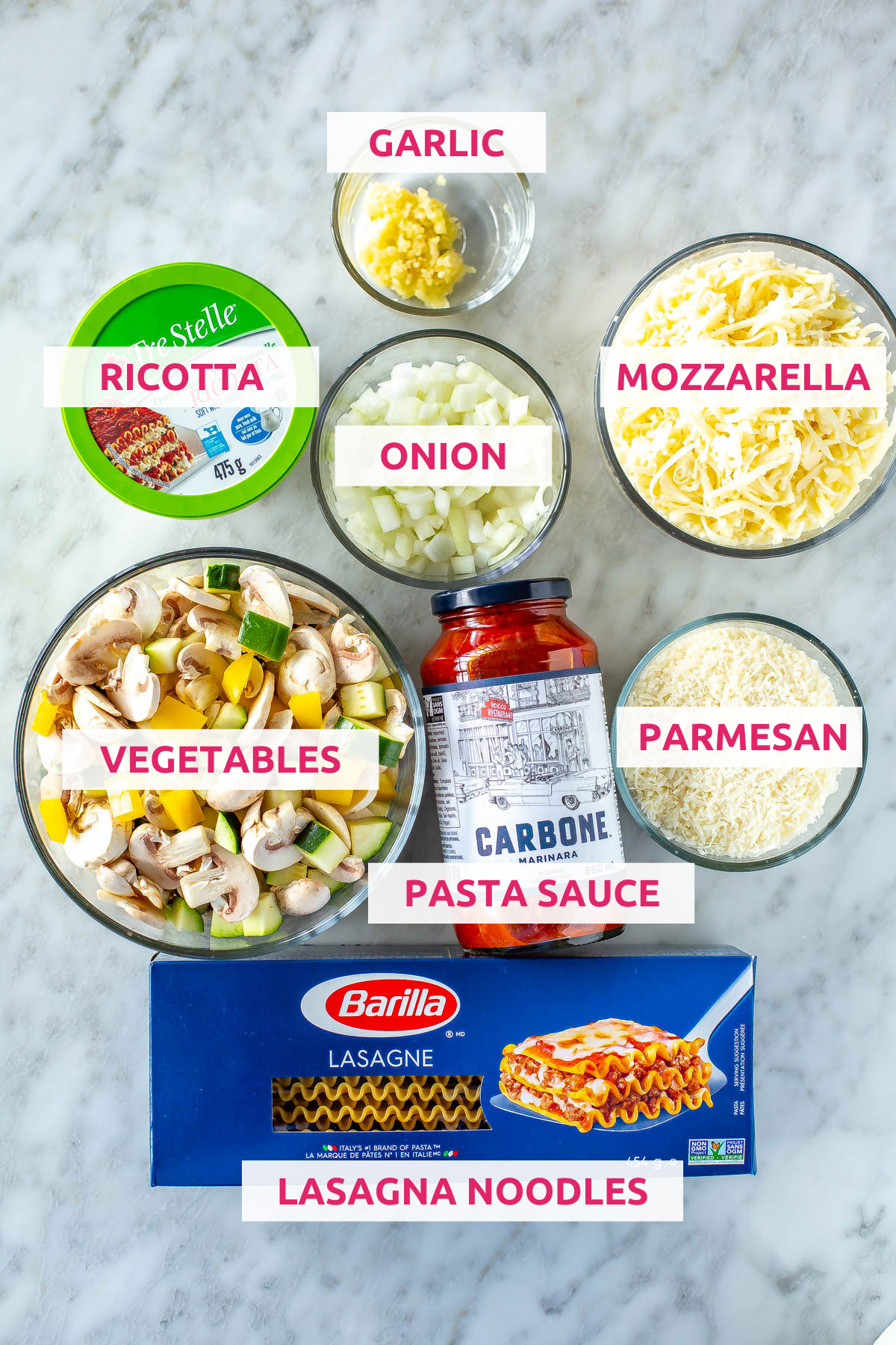 Ingredients for vegetarian lasagna: lasagna noodles, vegetables, pasta sauce, garlic, mozzarella, onion, ricotta and parmesan.