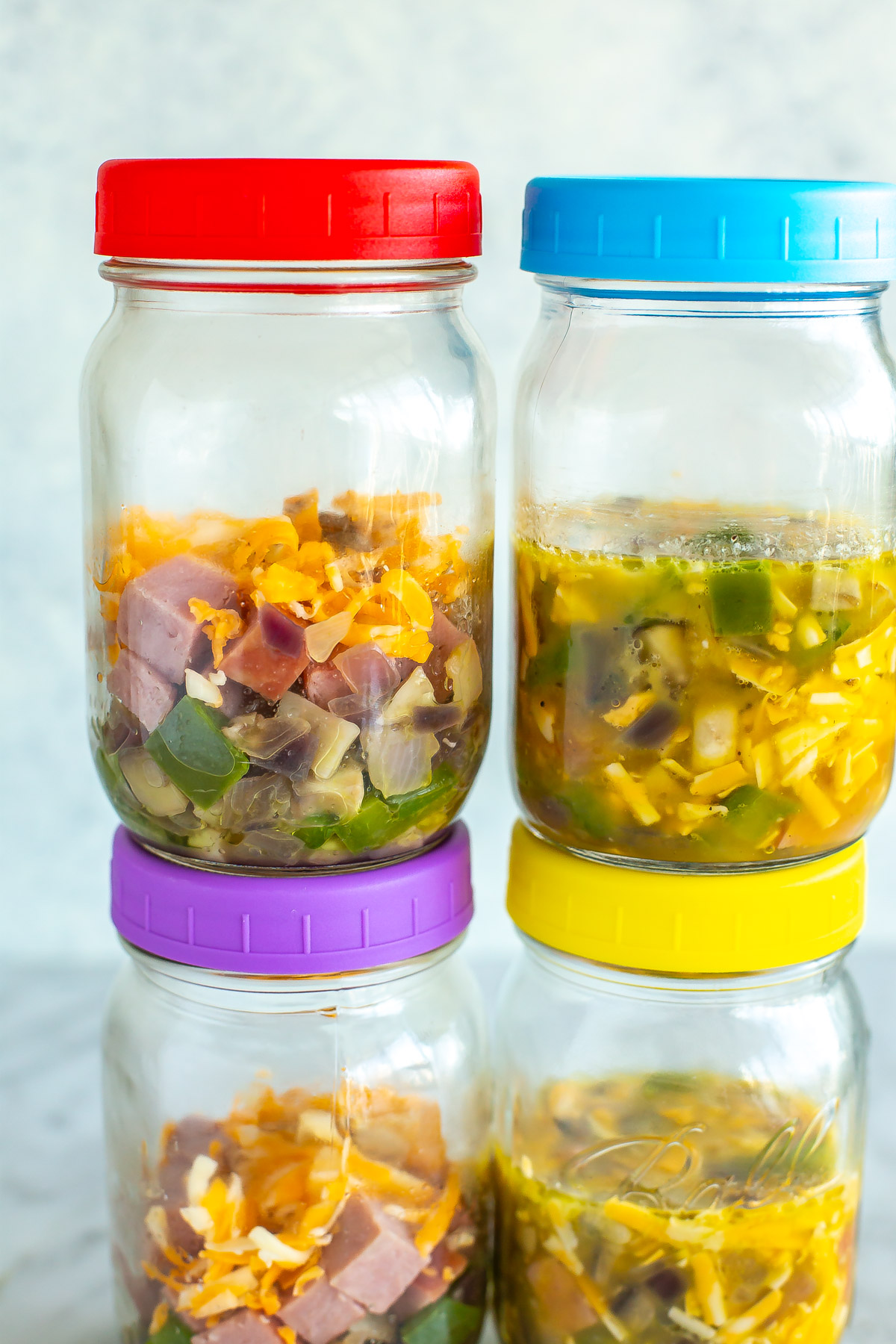 A close-up of mason jars with microwave omelettes inside.