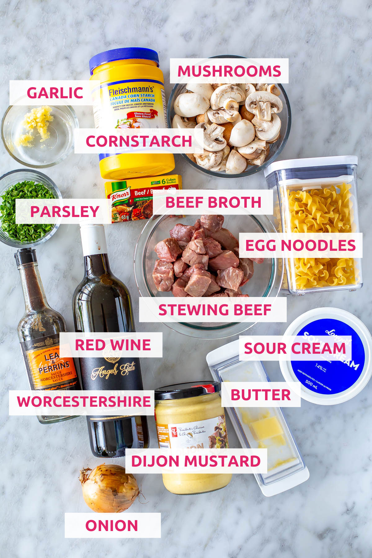 Ingredients for crockpot beef stroganoff: stewing beef, red wine, Worcestershire, dijon mustard, butter, sour cream, onion, parsley, egg noodles,  cornstarch, beef broth, mushrooms, and garlic.