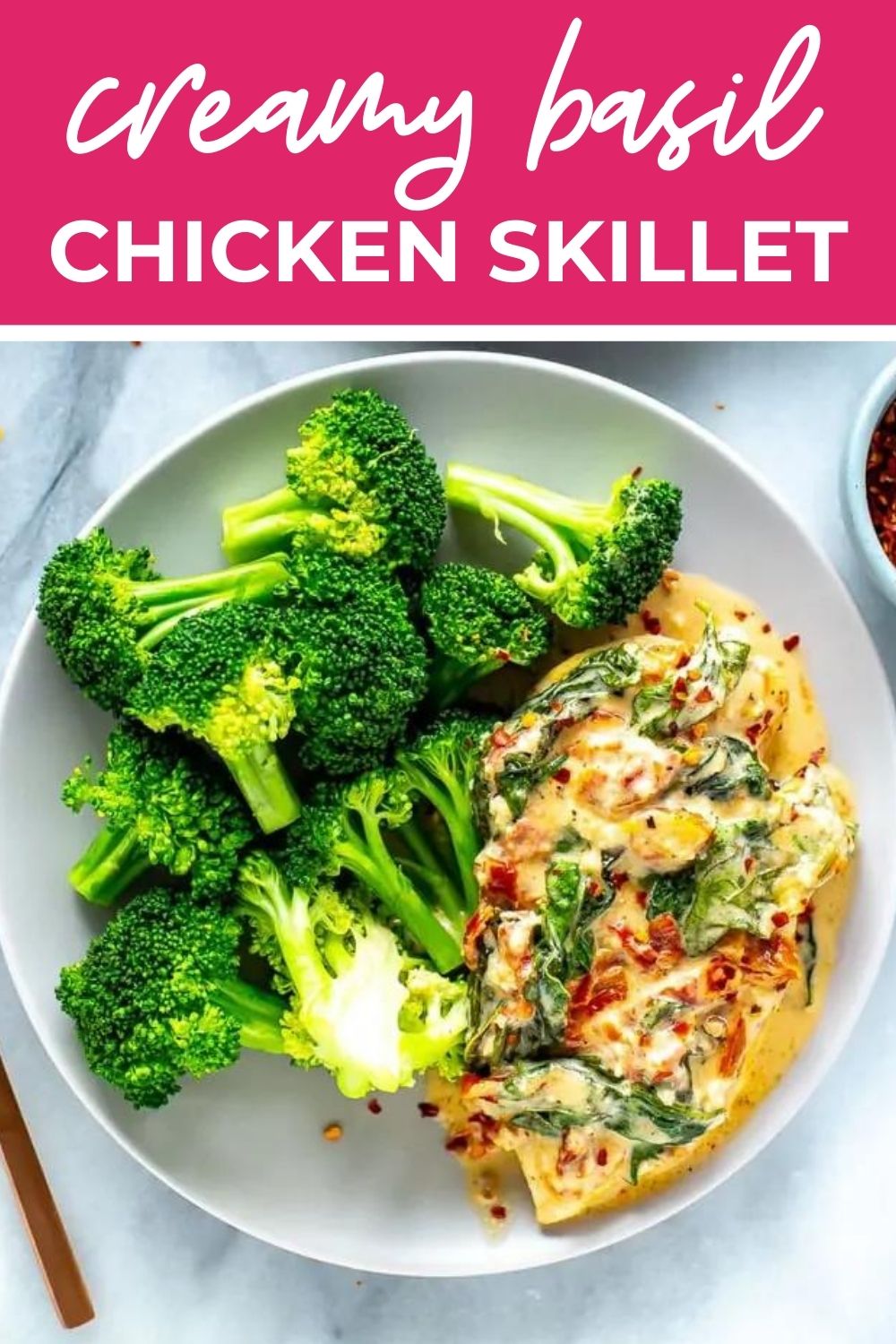 Overhead shot of creamy basil chicken and broccoli on a plate, with text that says 'Creamy Basil Chicken Skillet'