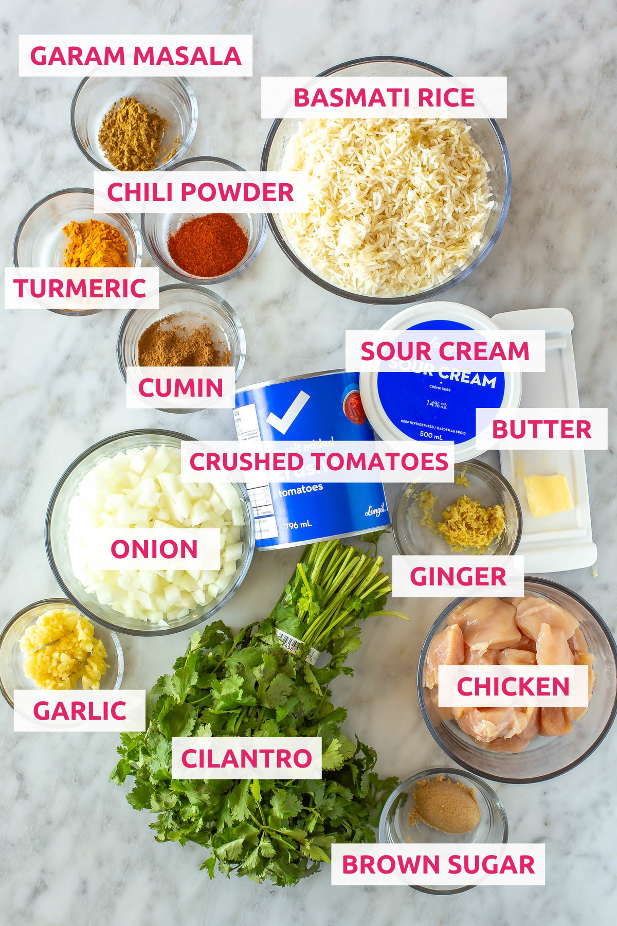 Ingredients for slow cooker chicken tikka masala: chicken, brown sugar, cilantro, ginger, garlic, onion, crushed tomatoes, sour cream, butter, cumin, turmeric, chili powder, garam masala, and basmati rice.