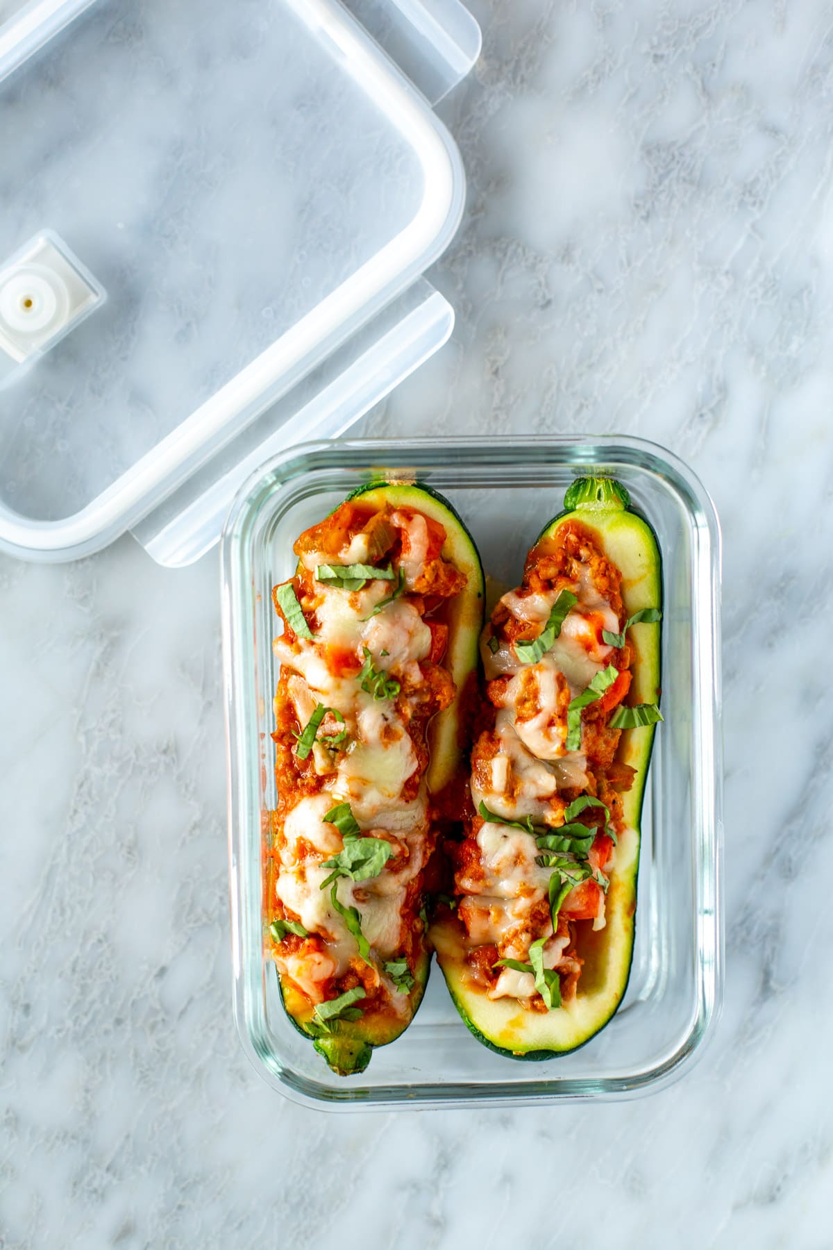 Italian zucchini boats in a glass meal prep container