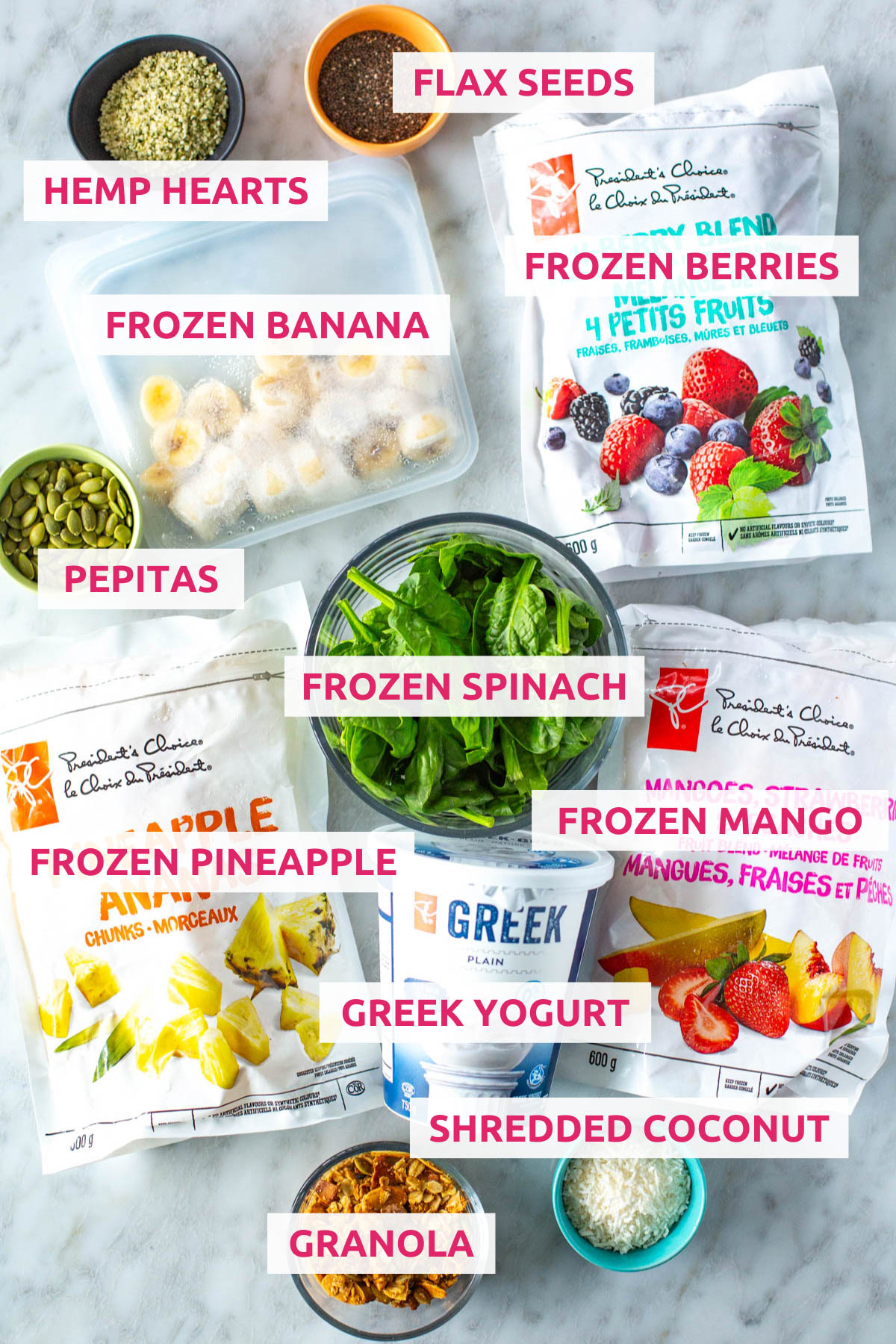Ingredients for smoothie bowls: hemp hearts, frozen bananas, flax seeds, frozen berries, pepitas, frozen berries, frozen pineapple, Greek yogurt, frozen mango, shredded coconut, and granola.