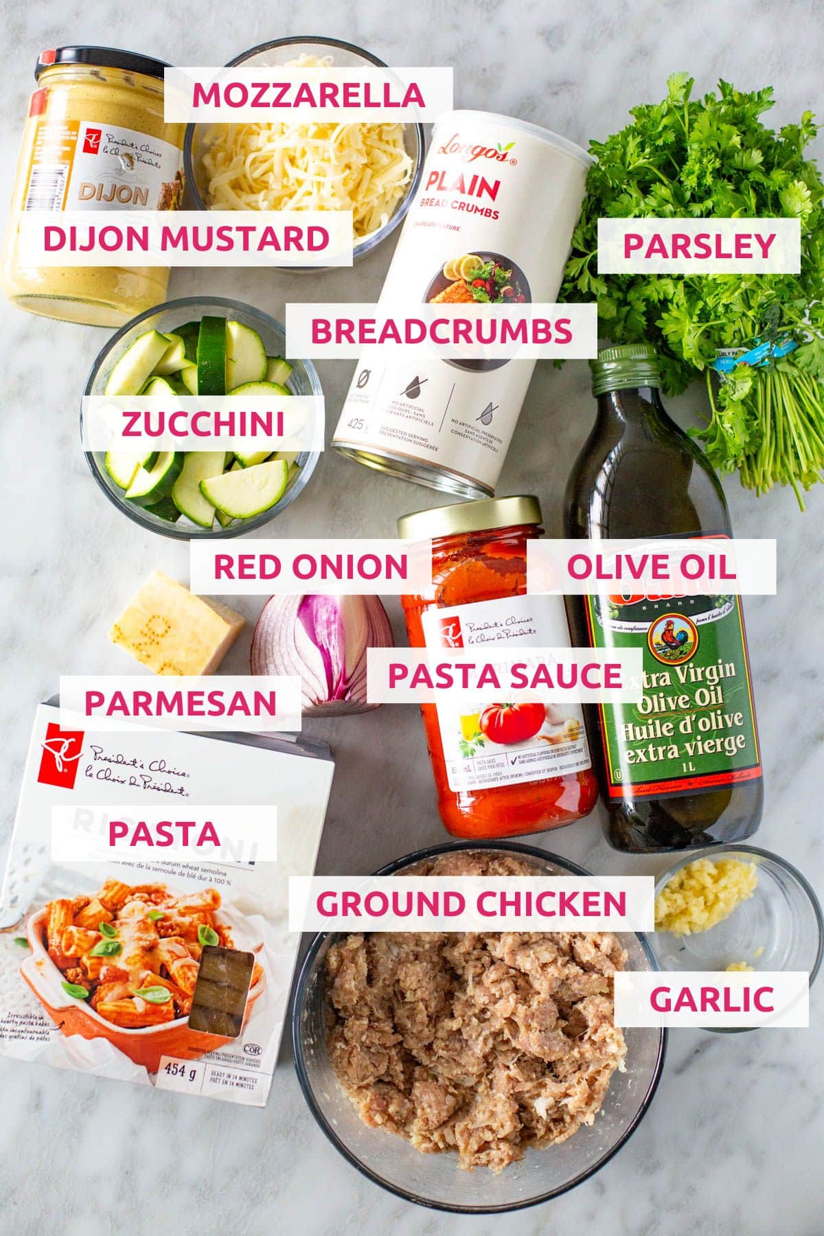Ingredients for chicken parmesan meatballs: Dijon mustard, mozzarella, breadcrumbs, parsley, zucchini, red onion, pasta sauce, olive oil, parmesan, pasta, ground chicken and garlic
