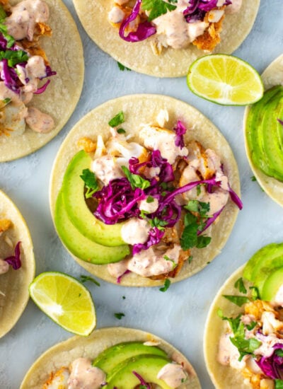 A close-up of homemade fish tacos with chipotle crema on top.
