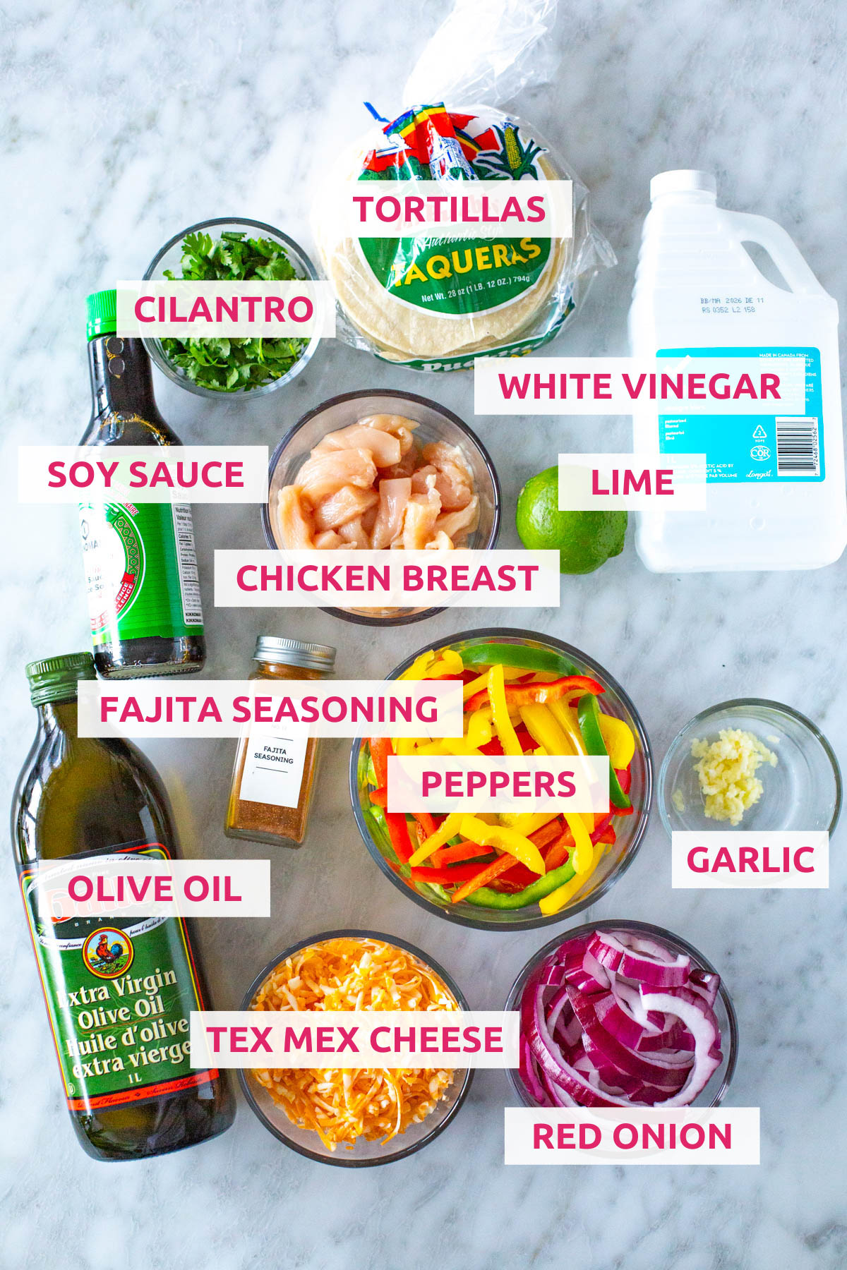Ingredients for sheet pan chicken fajitas: chicken breast, tex mex cheese, olive oil, red onion, peppers, garlic, fajita marinade, soy sauce, cilantro, corn tortillas, white vinegar and lime. 