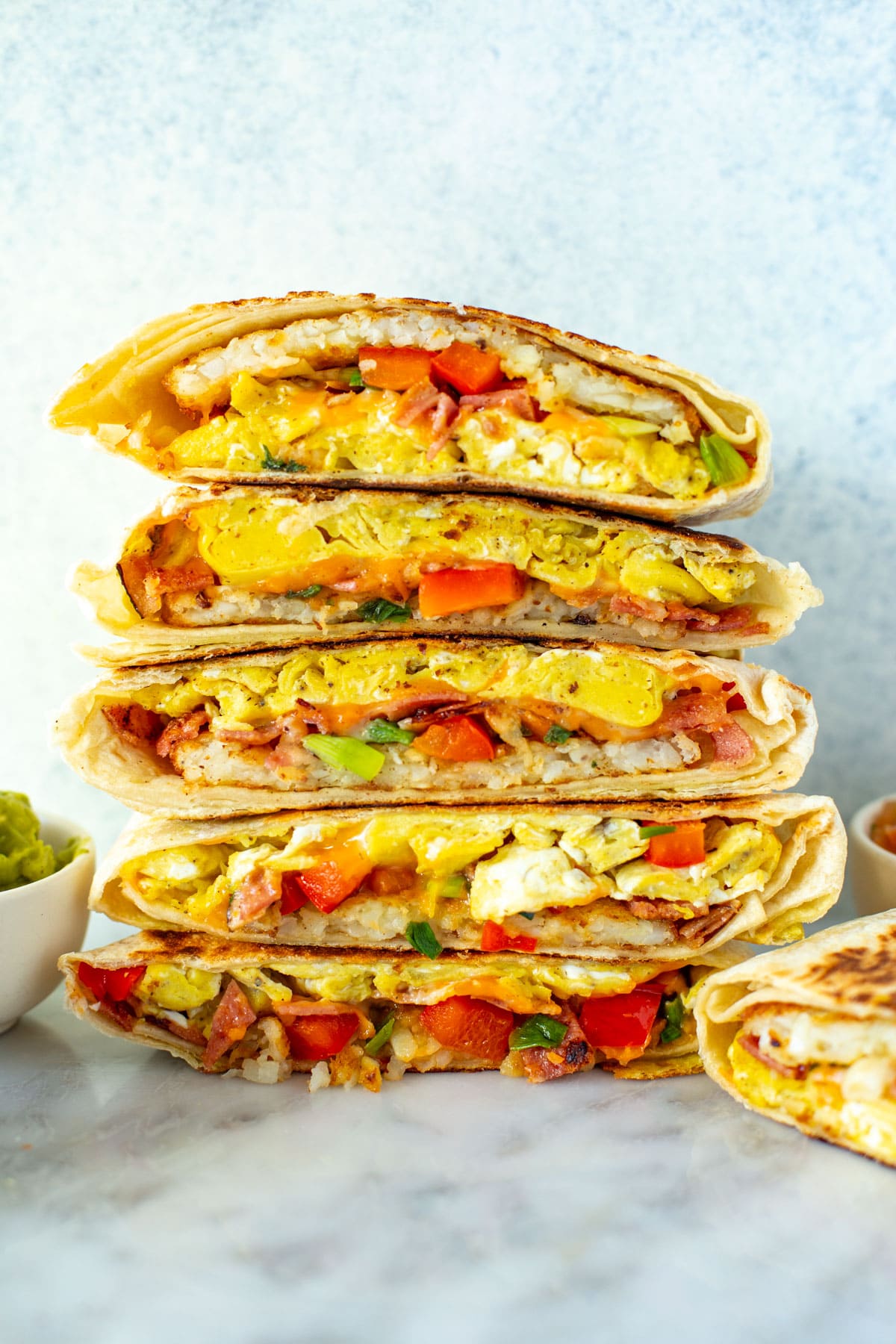 Cut open breakfast crunchwraps stacked together