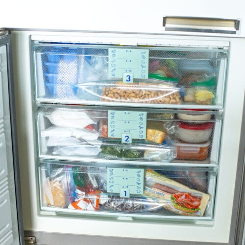 An organized freezer with 3 drawers.