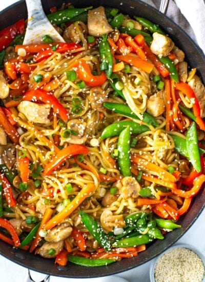 A close-up of chicken lo mein in a skillet.