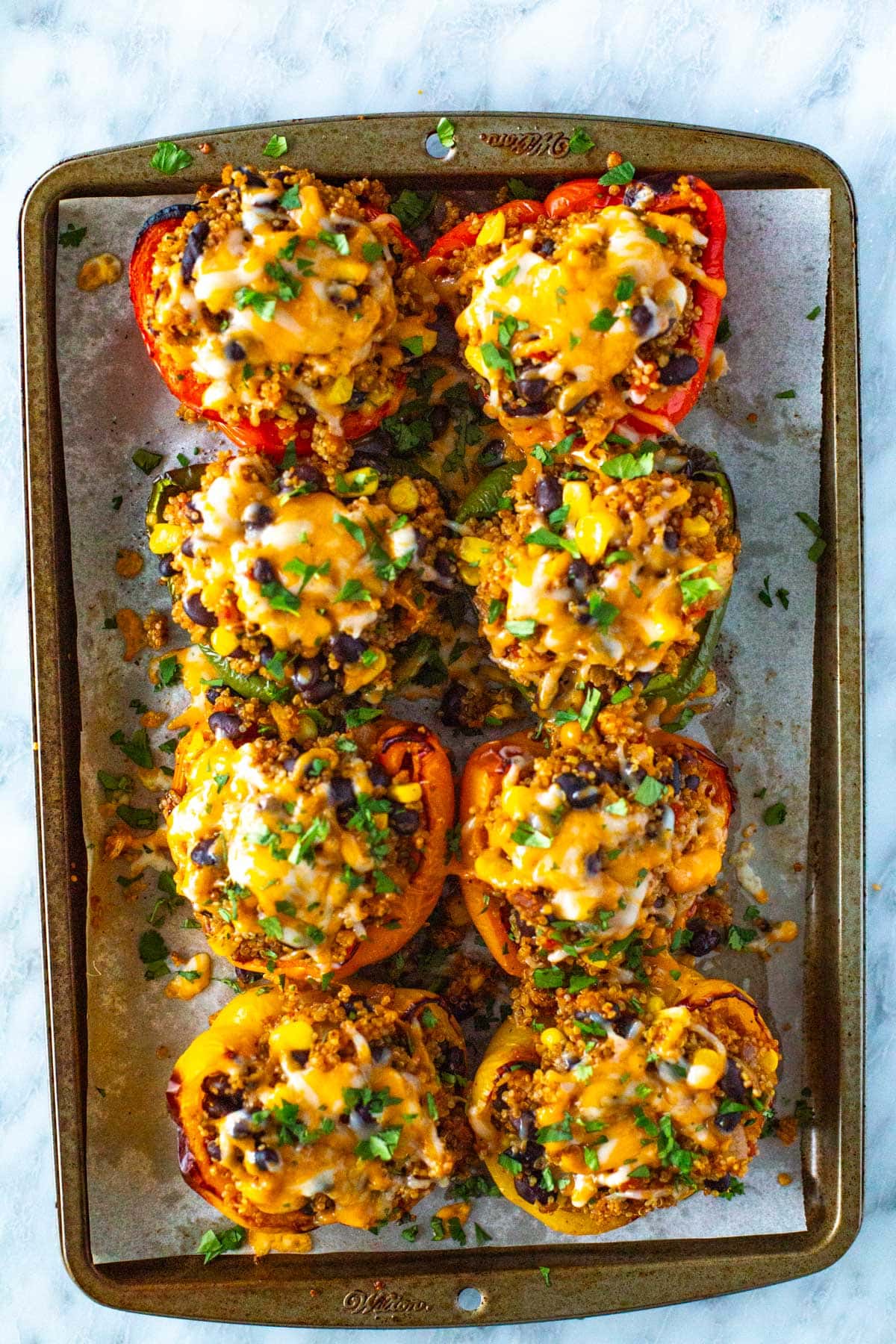 Vegetarian stuffed peppers on a sheet pan.