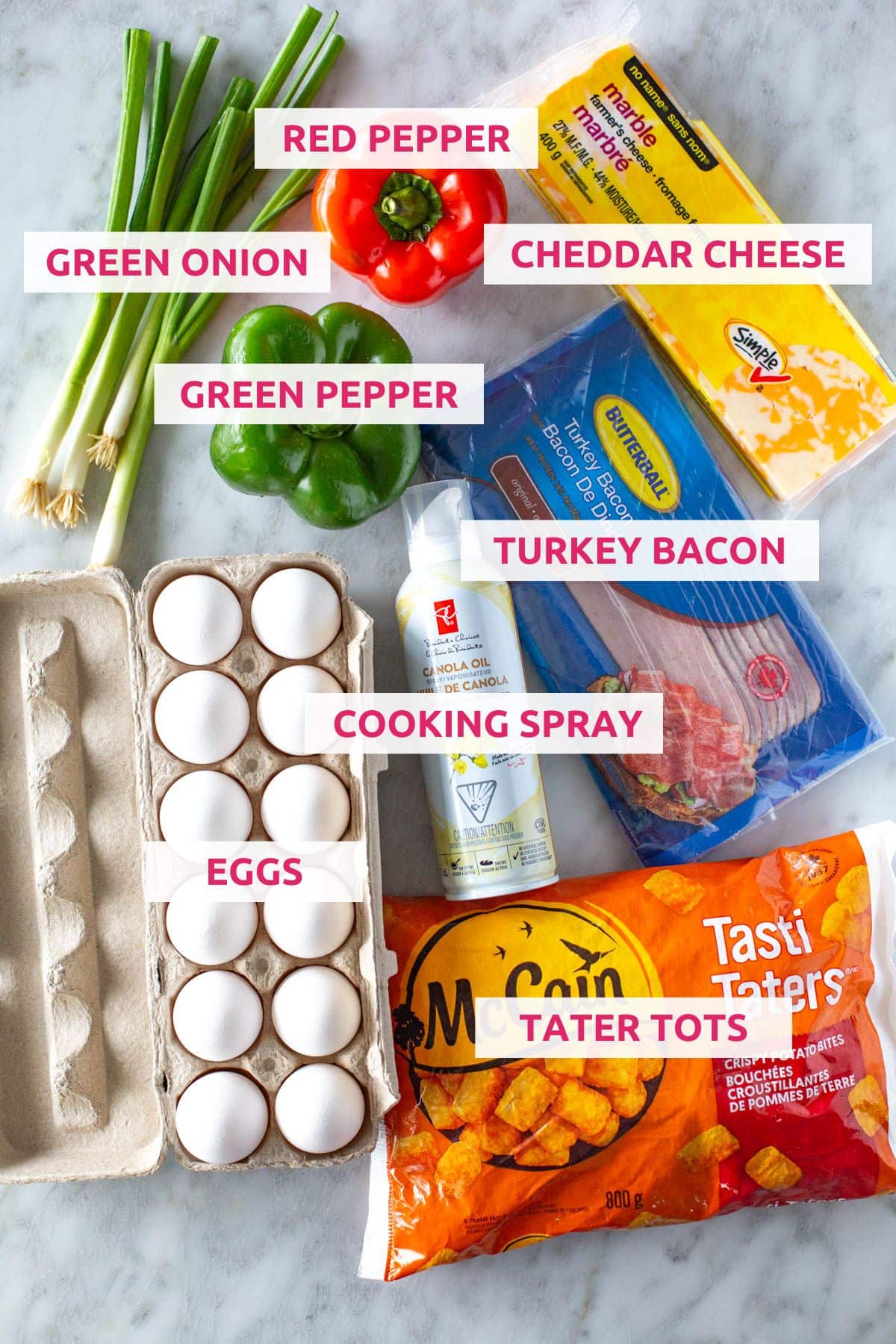 Ingredients for tater tot breakfast casserole: green onion, red pepper, cheddar cheese, green pepper, eggs, cooking spray, turkey bacon and tater tots