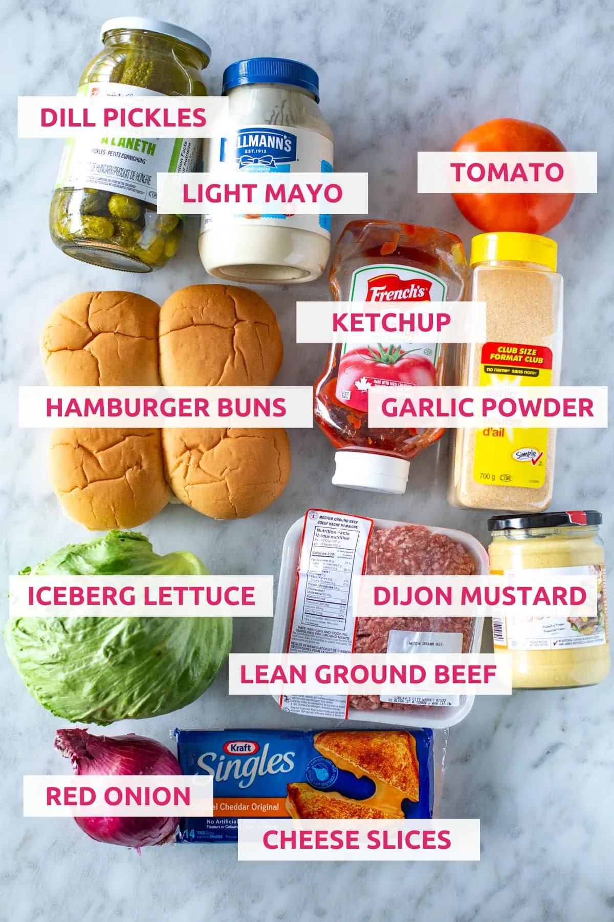 Ingredients for making smash burgers: dill pickles, light mayo, tomato, hamburger buns, ketchup, garlic powder, iceberg lettuce, ground beef, Dijon mustard, cheese slices and red onion.