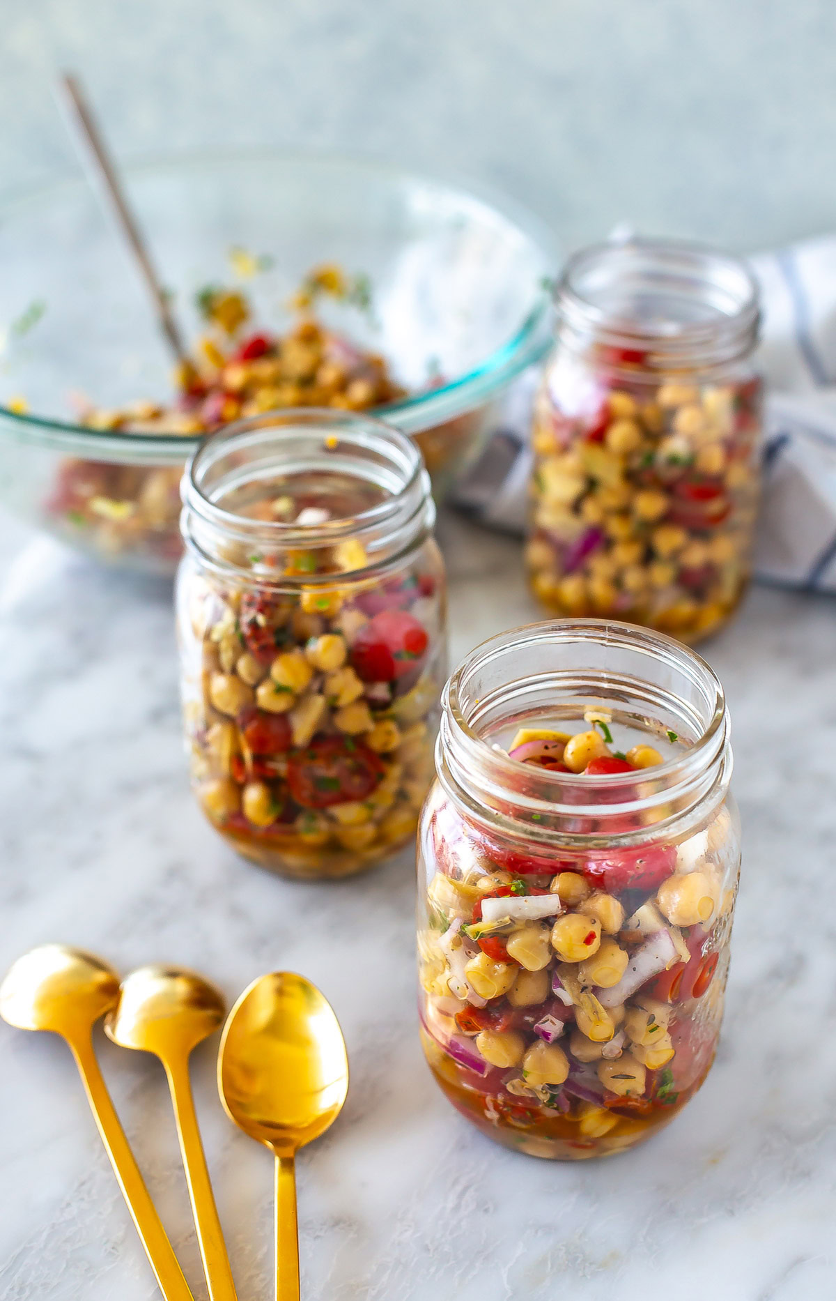 Overhead shot of the dish in mason jars - for recipe 15-Minute Mediterranean Chickpea Salad
