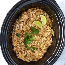 overhead shot of shredded chicken in a slow cooker - 1