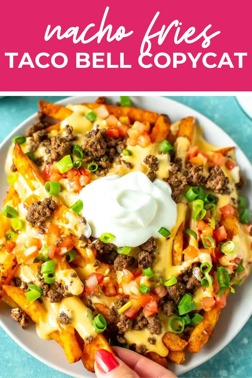 Overhead shot of plated dish with pink banner on the top- reading "nacho fries taco bell copycat"
