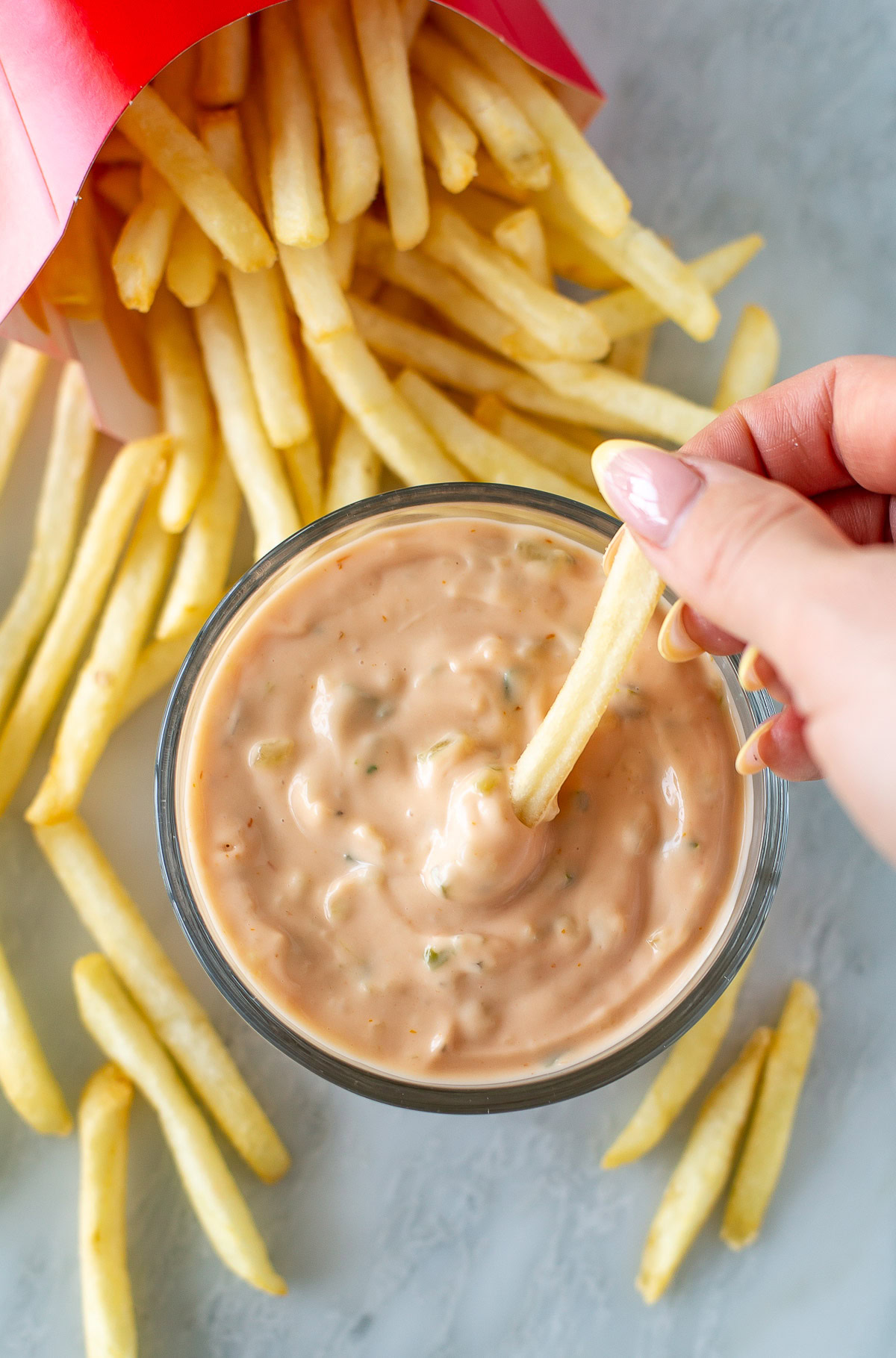 Overhead shot of big mac sauce in a small bowl, next to french fries - 3