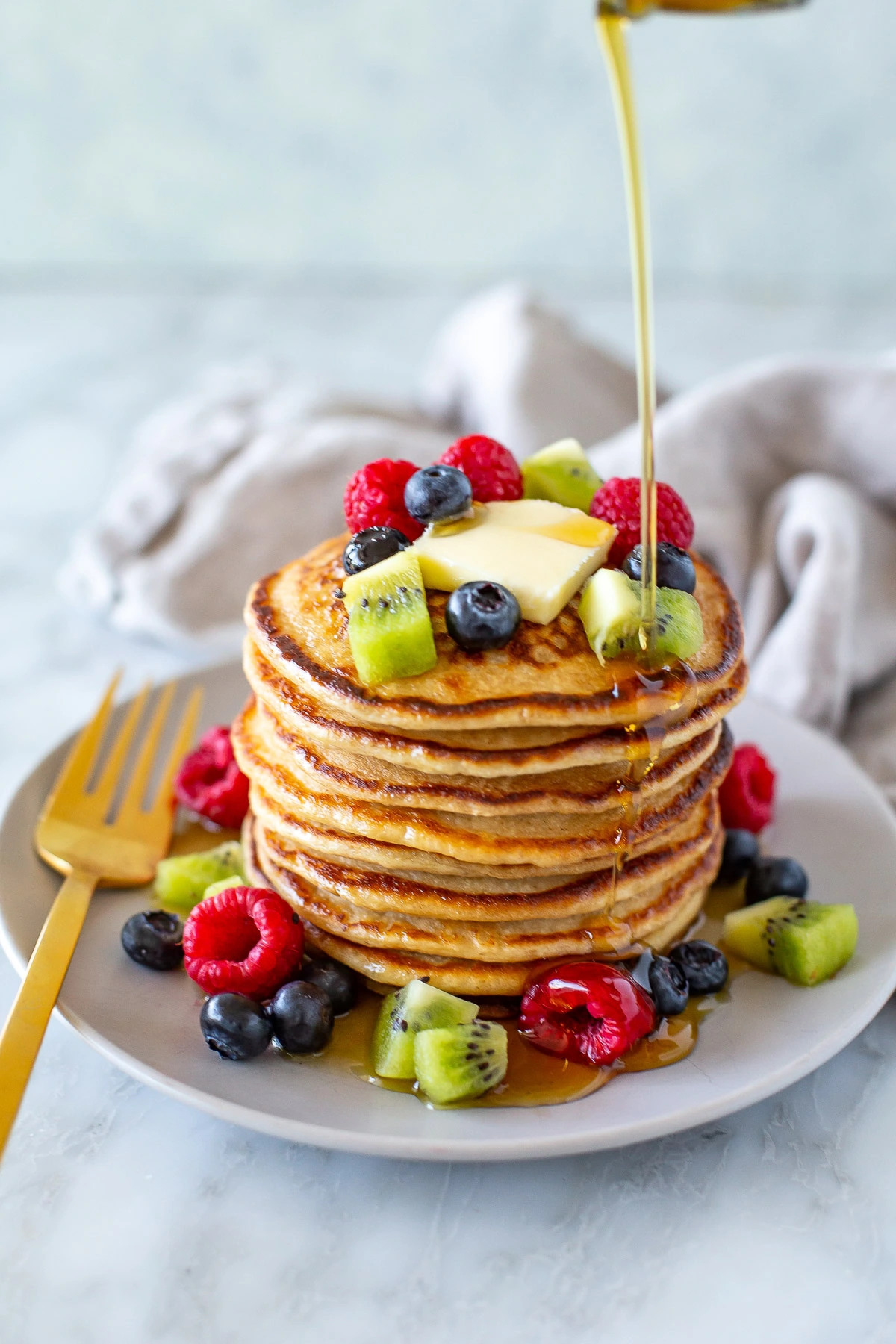 Overhead shot of cottage cheese pancakes with berries on top and around - 2