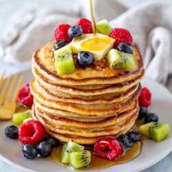 Overhead shot of cottage cheese pancakes with berries on top and around - 3