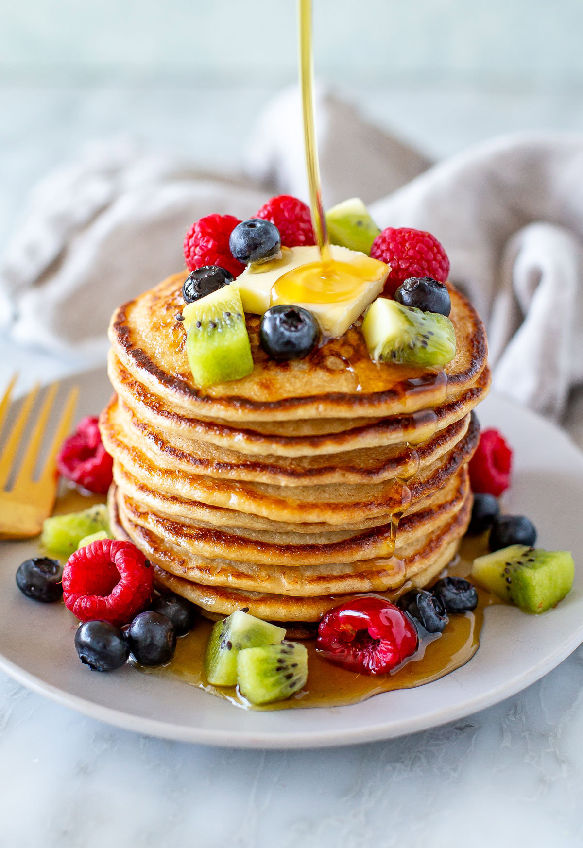 Overhead shot of cottage cheese pancakes with berries on top and around - 3