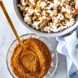 overhead shot of elote seasoning ready to use with popcorn on the side