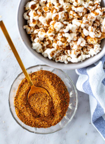 overhead shot of elote seasoning ready to use with popcorn on the side