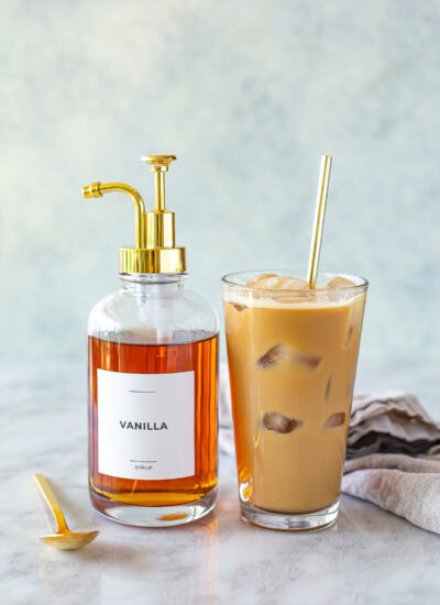 Side shot of homemade iced coffee and vanilla syrup pump