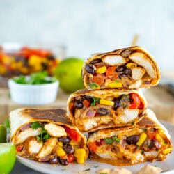 Side shot of a stack of cut Southwest chicken wraps on a plate 4