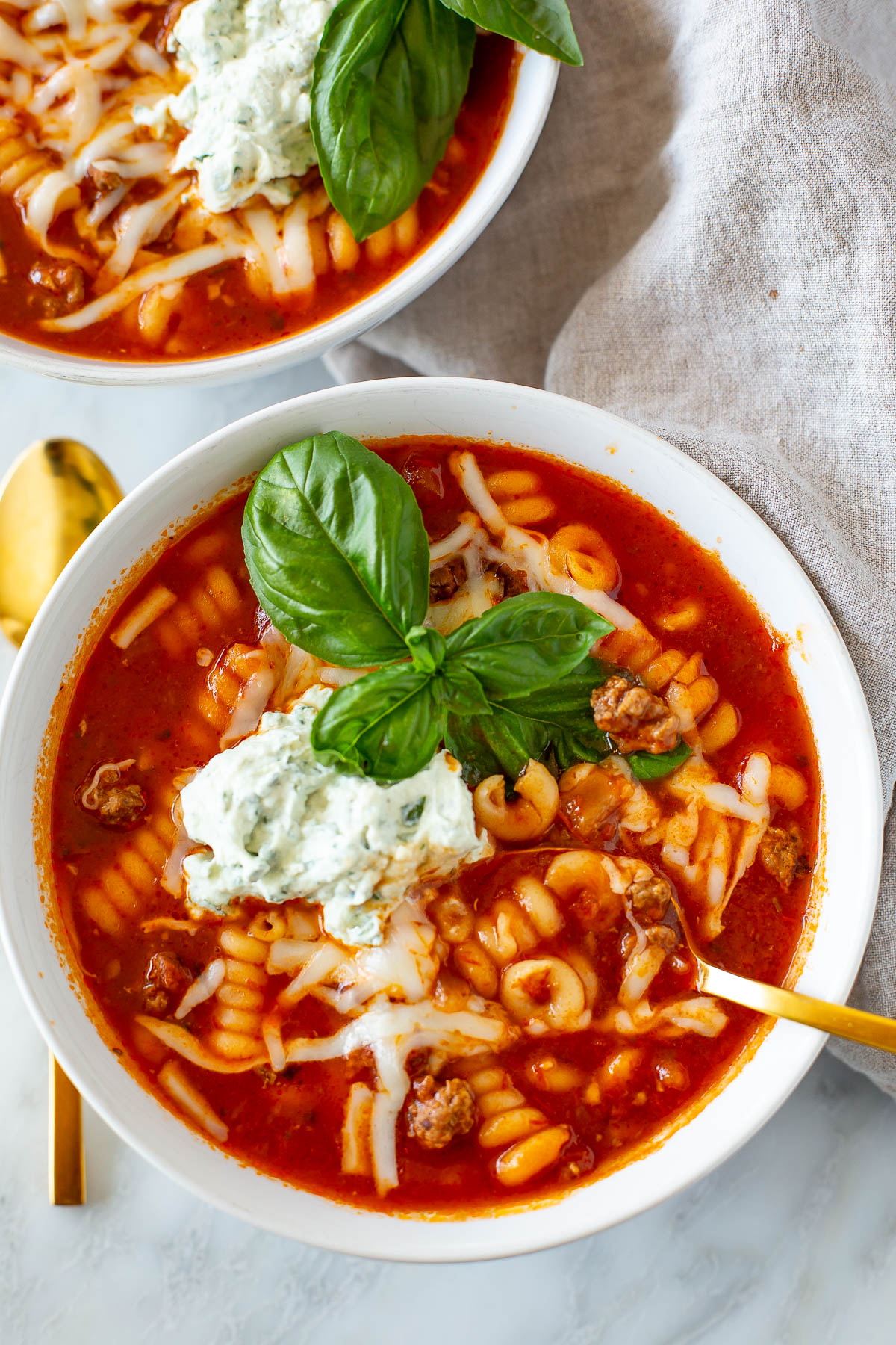 Overhead shot of a bowl of Easy Crockpot Lasagna Soup with a gold spoon.