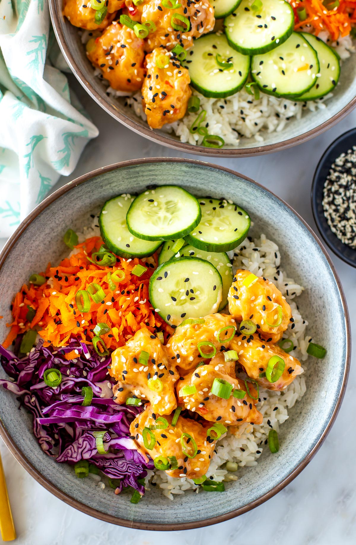 Overhead shot of two bowls of Bang Bang Chicken.