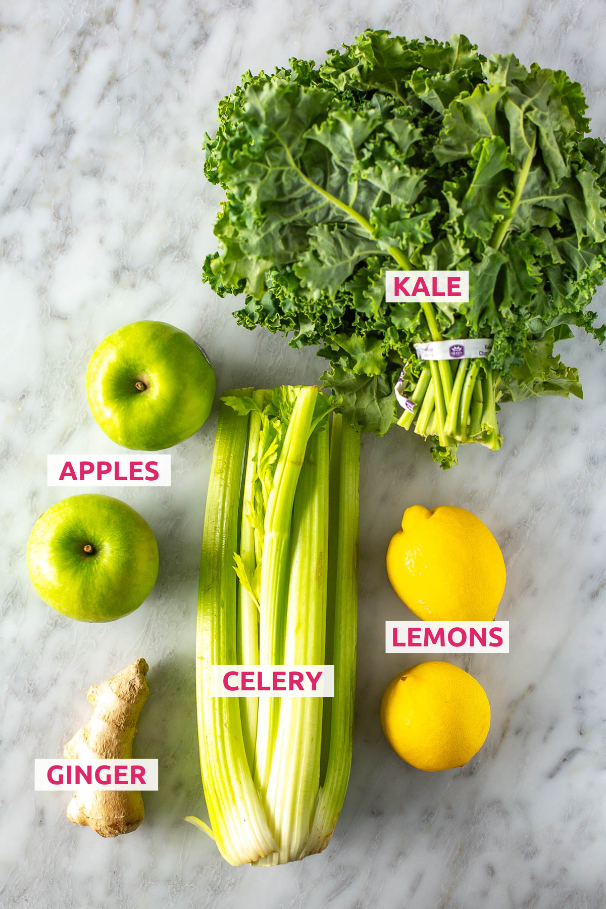 Overhead shot of Easy Green Juice ingredients, including kale, apples, celery, lemons, and ginger with labels.