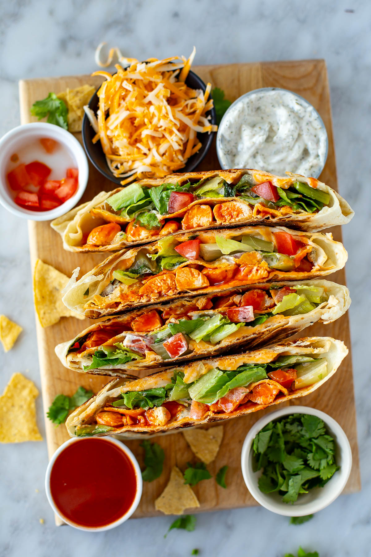 Overhead shot of buffalo chicken crunchwraps with ingredients