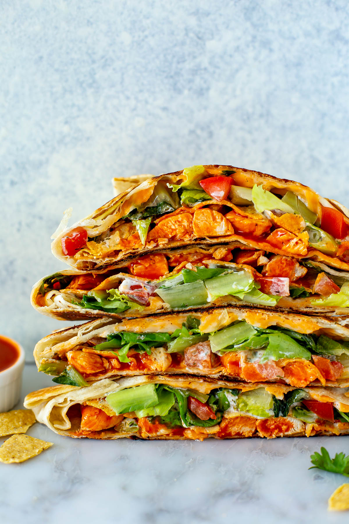 Closer shot of sideview stacked buffalo chicken crunchwraps.
