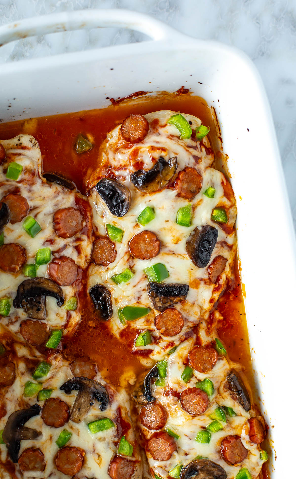 Close up of cooked Pizza Chicken in baking dish
