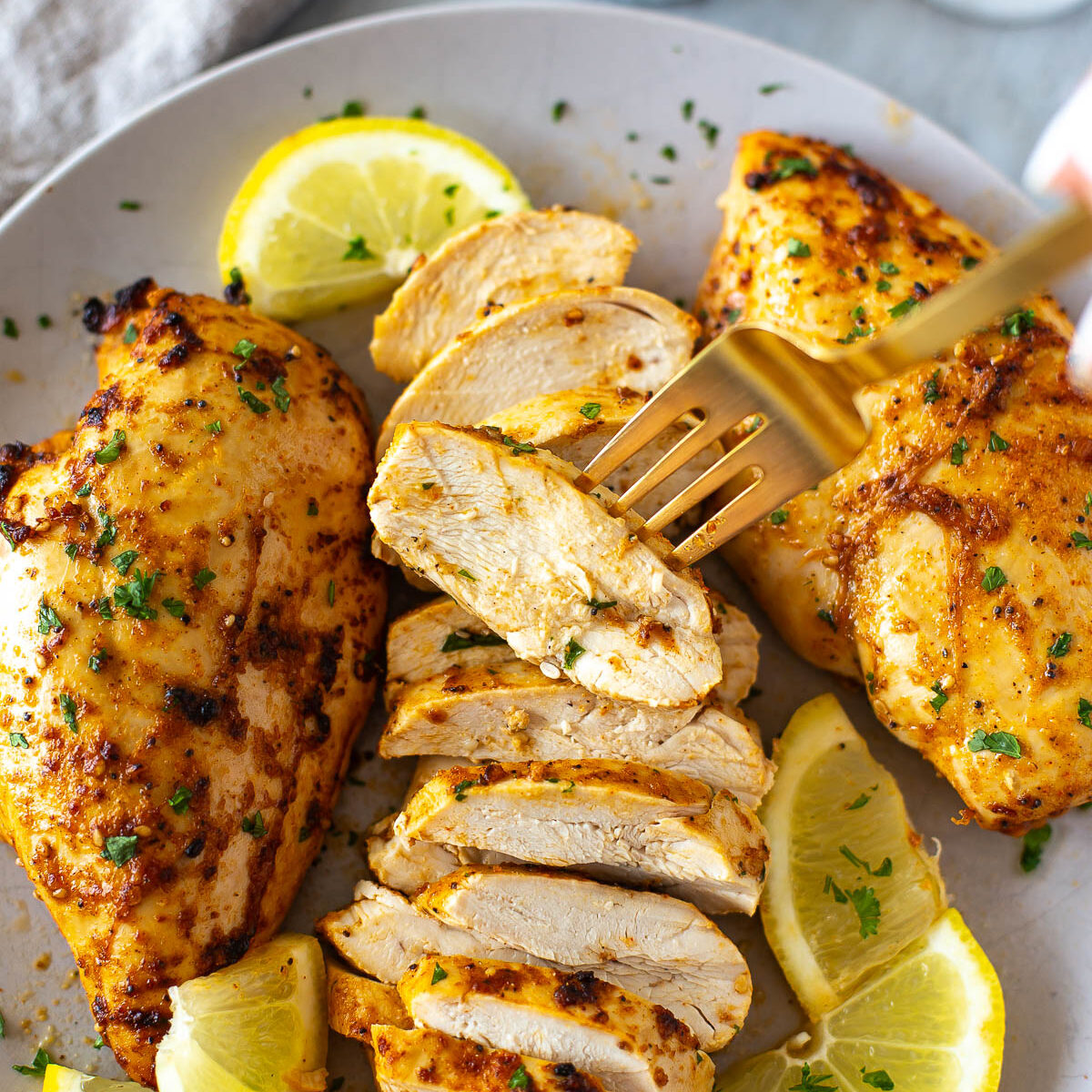 Sliced marinated chicken breast on a plate