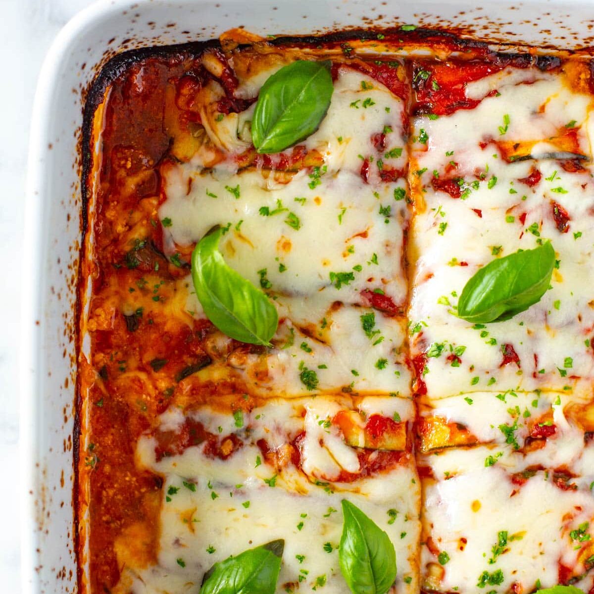 Close-up shot of cooked zucchini lasagna in a baking dish